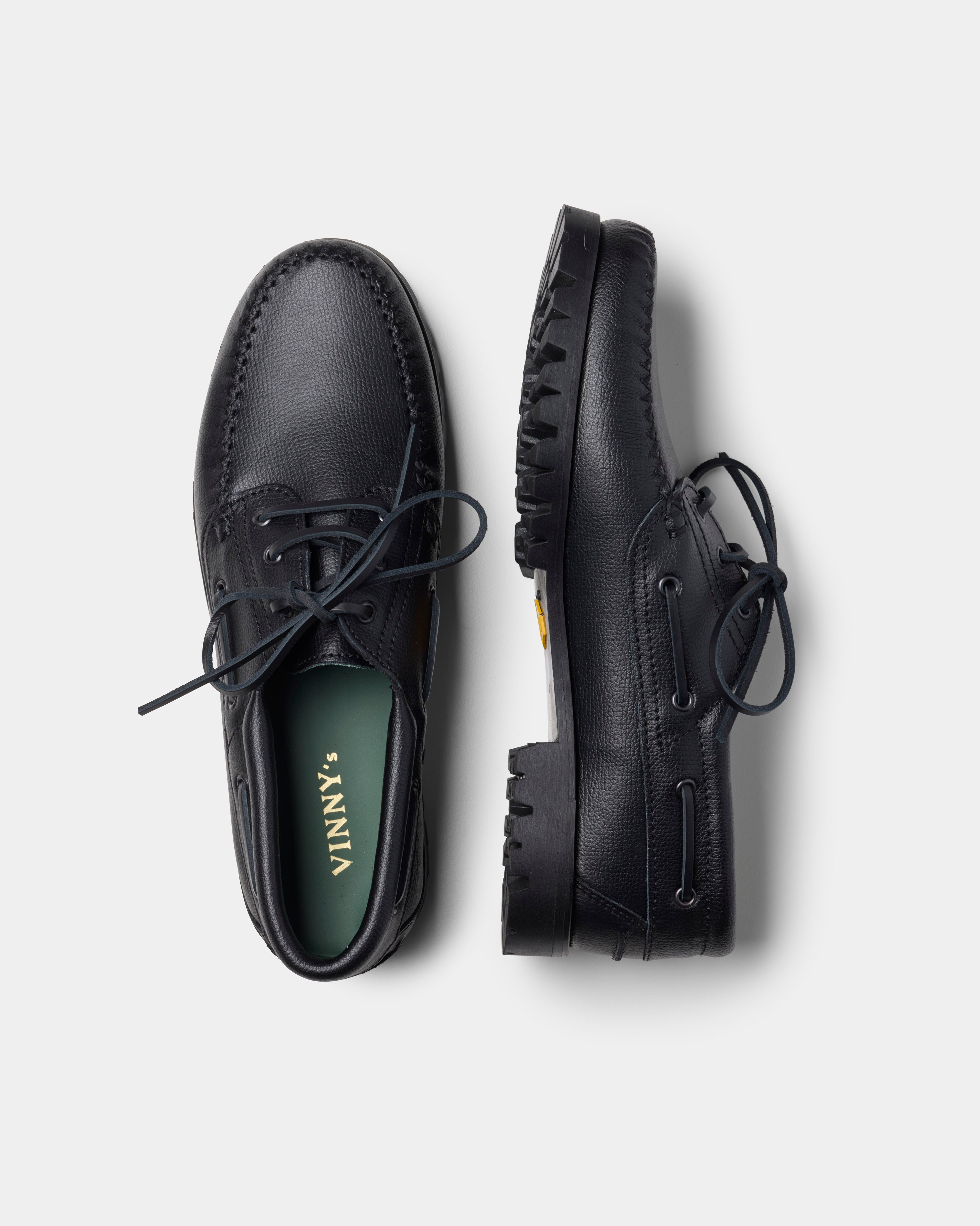 aztec boat shoe in black from the side and top